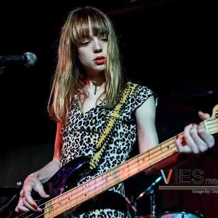 Emily Haine is playing the guitar.